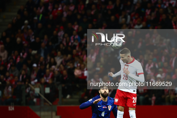 Josko Gvardiol of Croatia and Sebastian Szymanski during UEFA Nations League football match Poland - Croatia at National Stadium in Warsaw,...