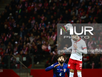 Josko Gvardiol of Croatia and Sebastian Szymanski during UEFA Nations League football match Poland - Croatia at National Stadium in Warsaw,...