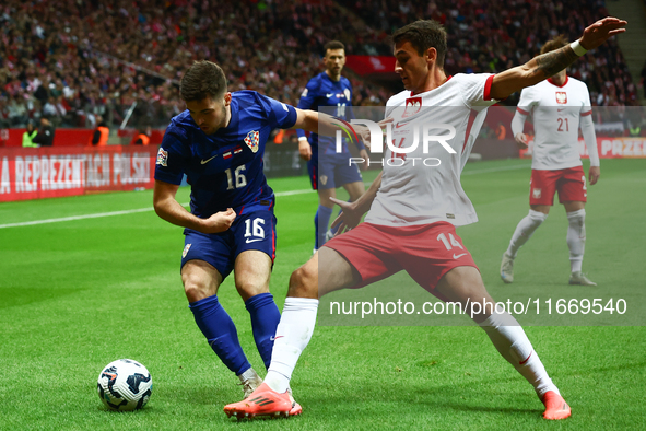 Martin Baturina of Croatia and Jakub Kiwior of Poland during UEFA Nations League football match Poland - Croatia at National Stadium in Wars...