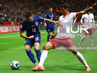 Martin Baturina of Croatia and Jakub Kiwior of Poland during UEFA Nations League football match Poland - Croatia at National Stadium in Wars...