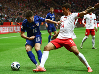 Martin Baturina of Croatia and Jakub Kiwior of Poland during UEFA Nations League football match Poland - Croatia at National Stadium in Wars...