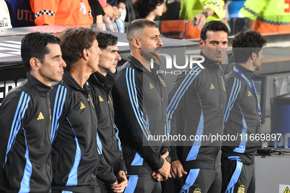 Lionel Scaloni, head coach of Argentina, and his assistant coaches stand during the national anthems ceremony before a match between Argenti...