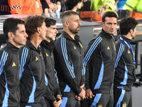 Lionel Scaloni, head coach of Argentina, and his assistant coaches stand during the national anthems ceremony before a match between Argenti...