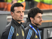 Lionel Scaloni and Pablo Aimar, coaches of Argentina, stand during the national anthems ceremony before a match between Argentina and Bolivi...