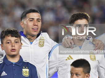 Enzo Fernandez and Julian Alvarez of Argentina stand during the national anthems ceremony before a match between Argentina and Bolivia at Es...