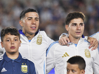 Enzo Fernandez and Julian Alvarez of Argentina stand during the national anthems ceremony before a match between Argentina and Bolivia at Es...