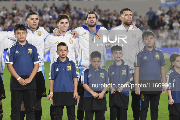 Enzo Fernandez, Julian Alvarez, Rodrigo De Paul, and Nicolas Otamendi of Argentina stand during the national anthems ceremony before a match...