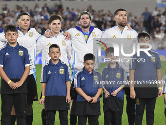 Enzo Fernandez, Julian Alvarez, Rodrigo De Paul, and Nicolas Otamendi of Argentina stand during the national anthems ceremony before a match...