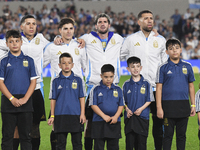 Enzo Fernandez, Julian Alvarez, Rodrigo De Paul, and Nicolas Otamendi of Argentina stand during the national anthems ceremony before a match...