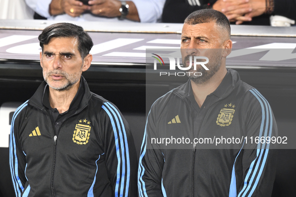 Roberto Ayala and Walter Samuel, assistant coaches of Argentina, stand during the national anthems ceremony before a match between Argentina...