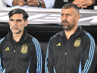 Roberto Ayala and Walter Samuel, assistant coaches of Argentina, stand during the national anthems ceremony before a match between Argentina...