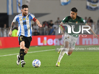 Lionel Messi of Argentina and Ramiro Vaca of Bolivia play during a match between Argentina and Bolivia at Estadio Mas Monumental Antonio Ves...