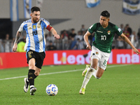 Lionel Messi of Argentina and Ramiro Vaca of Bolivia play during a match between Argentina and Bolivia at Estadio Mas Monumental Antonio Ves...