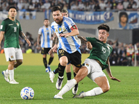 Lionel Messi of Argentina and Gabriel Villamil of Bolivia play during a match between Argentina and Bolivia at Estadio Mas Monumental Antoni...