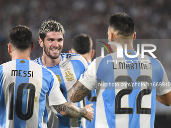 Lionel Messi, Rodrigo de Paul, and Lautaro Martinez celebrate their team's second goal during a match between Argentina and Bolivia at Estad...