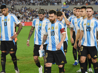 Cristian Romero, Lionel Messi, Alexis Mac Allister, Rodrigo De Paul, Julian Alvarez, Lautaro Martinez, and Nahuel Molina of Argentina stand...