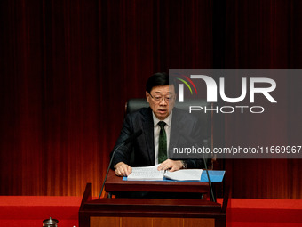 Hong Kong Chief Executive John Lee reads his 2024 Policy Address inside the Chambers of the Legislative Council in Hong Kong, China, on Octo...