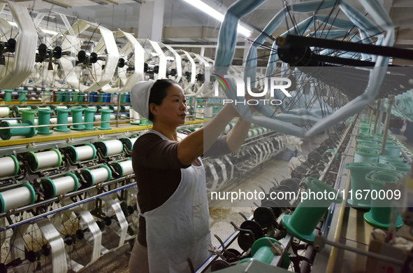 A worker works at a silk product production line of Anhui Jingjiu Silk Co in Fuyang, China, on October 16, 2024. 