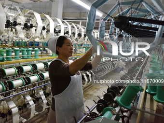 A worker works at a silk product production line of Anhui Jingjiu Silk Co in Fuyang, China, on October 16, 2024. (