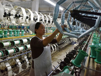 A worker works at a silk product production line of Anhui Jingjiu Silk Co in Fuyang, China, on October 16, 2024. (