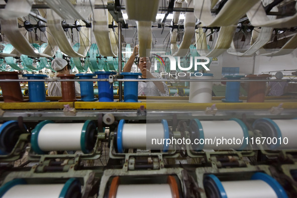 A worker works at a silk product production line of Anhui Jingjiu Silk Co in Fuyang, China, on October 16, 2024. 