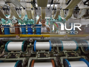 A worker works at a silk product production line of Anhui Jingjiu Silk Co in Fuyang, China, on October 16, 2024. (