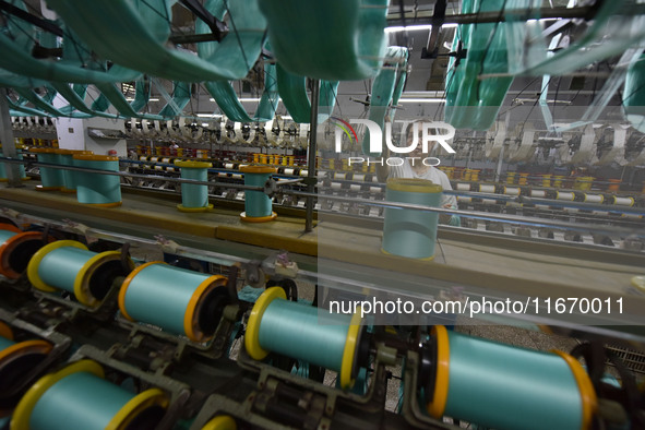 A worker works at a silk product production line of Anhui Jingjiu Silk Co in Fuyang, China, on October 16, 2024. 