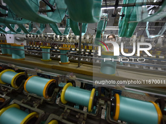 A worker works at a silk product production line of Anhui Jingjiu Silk Co in Fuyang, China, on October 16, 2024. (