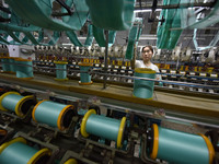 A worker works at a silk product production line of Anhui Jingjiu Silk Co in Fuyang, China, on October 16, 2024. (