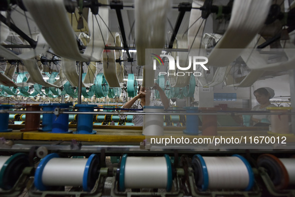 A worker works at a silk product production line of Anhui Jingjiu Silk Co in Fuyang, China, on October 16, 2024. 