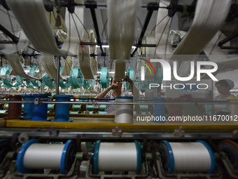 A worker works at a silk product production line of Anhui Jingjiu Silk Co in Fuyang, China, on October 16, 2024. (