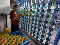 A worker works at a silk product production line of Anhui Jingjiu Silk Co in Fuyang, China, on October 16, 2024. (