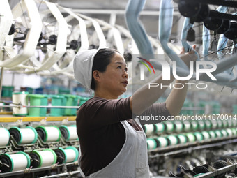 A worker works at a silk product production line of Anhui Jingjiu Silk Co in Fuyang, China, on October 16, 2024. (