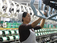 A worker works at a silk product production line of Anhui Jingjiu Silk Co in Fuyang, China, on October 16, 2024. (