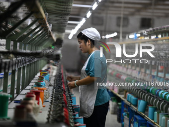 A worker works at a silk product production line of Anhui Jingjiu Silk Co in Fuyang, China, on October 16, 2024. (