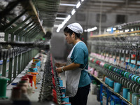 A worker works at a silk product production line of Anhui Jingjiu Silk Co in Fuyang, China, on October 16, 2024. (