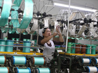 A worker works at a silk product production line of Anhui Jingjiu Silk Co in Fuyang, China, on October 16, 2024. (