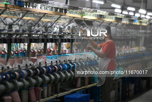 A worker works at a silk product production line of Anhui Jingjiu Silk Co in Fuyang, China, on October 16, 2024. 