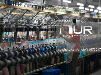 A worker works at a silk product production line of Anhui Jingjiu Silk Co in Fuyang, China, on October 16, 2024. (