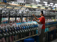 A worker works at a silk product production line of Anhui Jingjiu Silk Co in Fuyang, China, on October 16, 2024. (