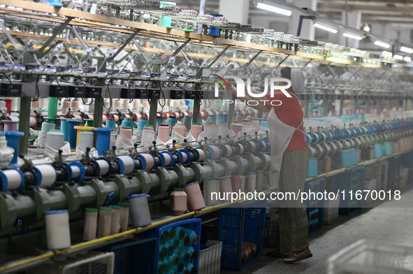 A worker works at a silk product production line of Anhui Jingjiu Silk Co in Fuyang, China, on October 16, 2024. 