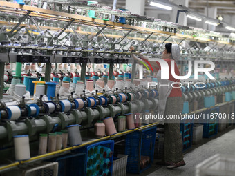 A worker works at a silk product production line of Anhui Jingjiu Silk Co in Fuyang, China, on October 16, 2024. (