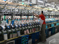 A worker works at a silk product production line of Anhui Jingjiu Silk Co in Fuyang, China, on October 16, 2024. (