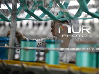 A worker works at a silk product production line of Anhui Jingjiu Silk Co in Fuyang, China, on October 16, 2024. (