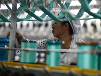 A worker works at a silk product production line of Anhui Jingjiu Silk Co in Fuyang, China, on October 16, 2024. (