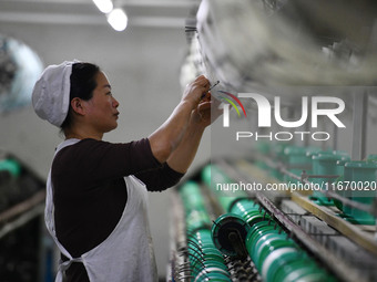 A worker works at a silk product production line of Anhui Jingjiu Silk Co in Fuyang, China, on October 16, 2024. (