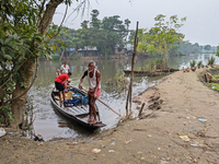 Fishermen go to sell fish in a rural market in a rural area in Feni, Bangladesh, on October 16, 2024. Many fish enclosures and ponds are was...