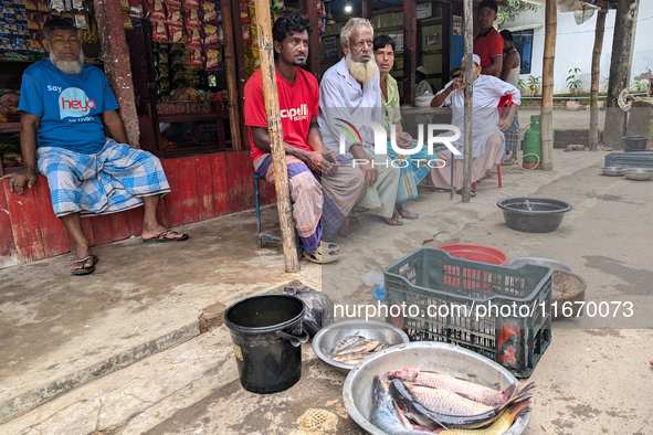 Fishes are kept in a bowl to sell in a rural area in Feni, Bangladesh, on October 16, 2024. Many fish enclosures and ponds are washed away,...