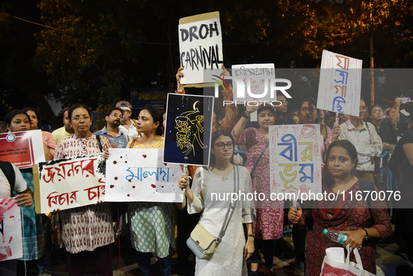 People hold placards as they attend the 'Droh carnival', a human-chain protest demonstration against the rape and murder of a junior doctor...