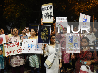 People hold placards as they attend the 'Droh carnival', a human-chain protest demonstration against the rape and murder of a junior doctor...